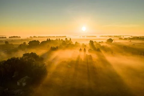 A mesmerizing shot of a beautiful sunrise with the sun rays spreading all ove Stock Photos