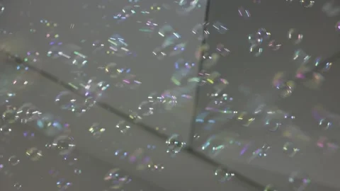 Mesmerizing shot of floating bubbles, glistening with iridescent hues drift Stock Footage 286272312