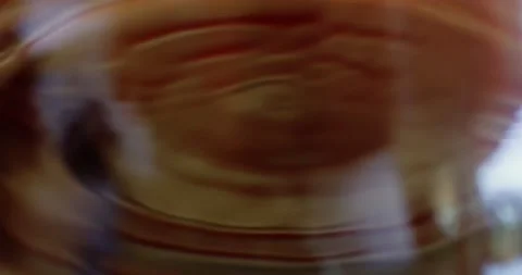 Mesmerizing shot showing in slow motion a drop of coffee. Video stock 221243383