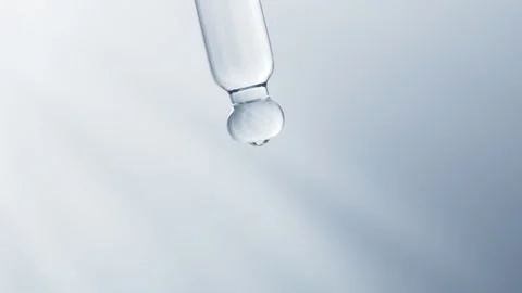 A mesmerizing slow motion capture of a clear liquid droplet gracefully deta.. Stock Footage 332384568
