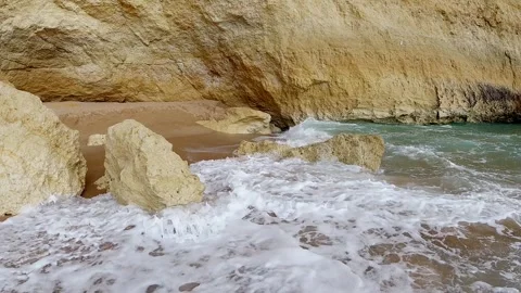 Mesmerizing Slow Motion Wave Caressing Golden Beach in Algarve Cave Stock Footage 308928749