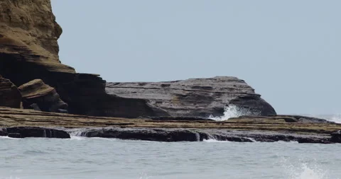 Mesmerizing Slow Motion Waves Crashing on Rocky Beach - High-Quality Stock Video stock 240966459