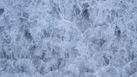 Mesmerizing slow-motion whitewater waves churn ocean after storm, topdown aerial Stock Footage 112704124