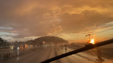 A mesmerizing Sunset Drive along Rainsoaked Roads under Dramatic and Stunning Video stock 314943771