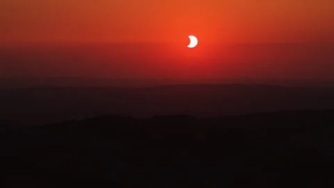 A mesmerizing timelapse of solar eclipse at sunset, captured in Sud Bourgogne Stock Footage 343007324