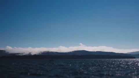 A mesmerizing timelapse video captures the beauty of mountains and clouds in a Stock Footage 241045356