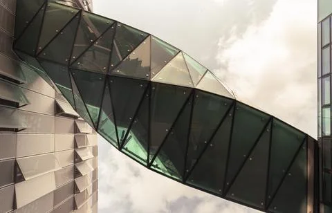 A mesmerizing, twisted sky bridge crafted from reflective glass and geometr.. Stock Photos