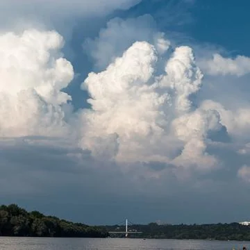 A mesmerizing view of the cloudscape over the bridge and Danube river in Novi Stock Photos
