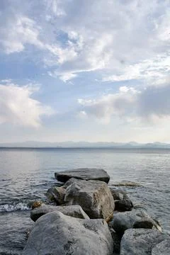 Mesmerizing view of Lake Sevan and the cloudy blue sky Stock Photos