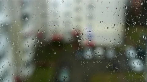 A mesmerizing view on a rainy day seen through a window, featuring drops of Video stock 305280062