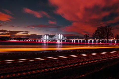 Mesmerizing view of the scenic cloudscape over the bridge in the evening Stock Photos