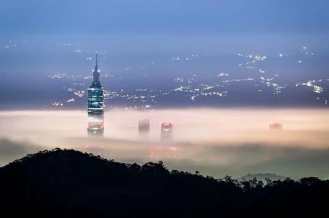 A mesmerizing white mist hangs over Taipei. Urban Glow: City Colorful Skyline. Stock Photos