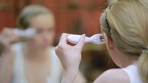 Mesotherapy at home. Girl mesorollerom handles the face of the house. Stock Footage