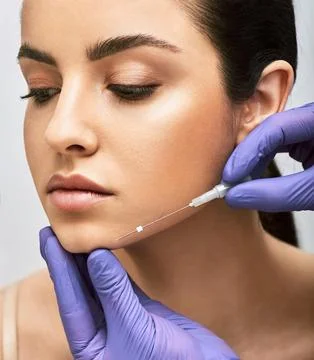 Mesothreads facial. Face contour lifting procedure, a needle with mesothreads Fotos Stock