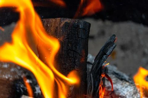 Mesquite log set ablaze by a massive orange flame Stock Photos