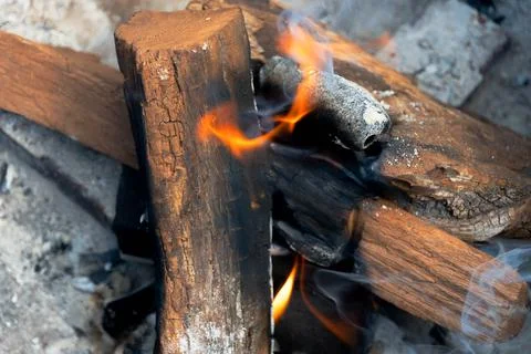 Mesquite logs on fire inside a fire pit Stock Photos