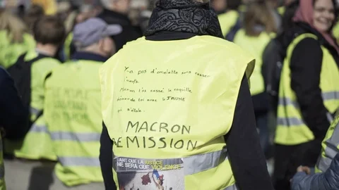 Message against Macron on a yellow vest at Vieux Port, Gilets Jaunes protest Stock Footage 104538787
