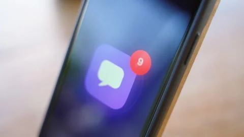 Message app icon with unread notification badge on smartphone in dark. Glowing Stock Footage 342735172
