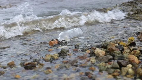 Message in the bottle against the Sun setting down Stock Footage 152037964