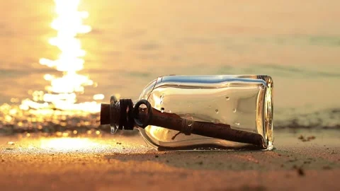 Message in the bottle against the Sun setting down Stock Footage 152935432