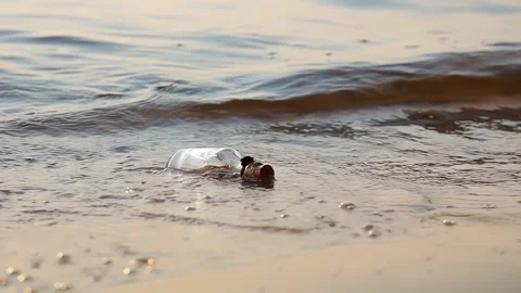 Message in the bottle against the Sun setting down Stock Footage 291530498