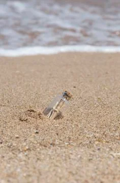Message in a bottle on beach Stock Photos