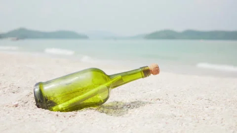 Message in a bottle (MIB) on a sand beach Stock Footage 244565289