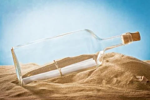 Message in bottle on sand Stock Photos