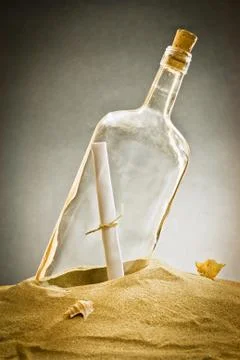Message in bottle on sand Stock Photos