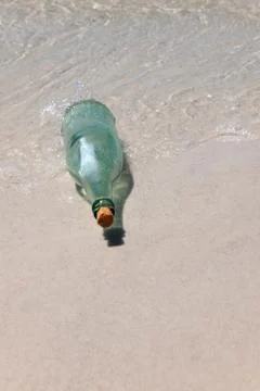 Message in a Bottle on Sand Stock Photos