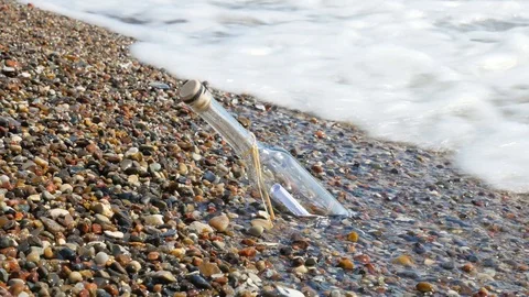 Message in a bottle, stranded bottle on the beach Stock Footage 90523369