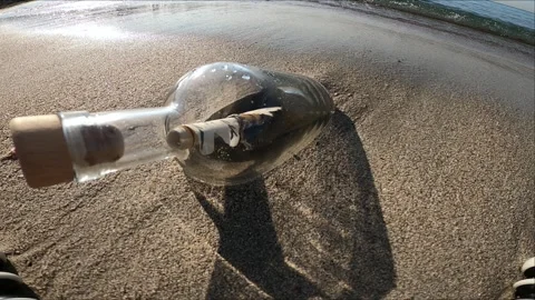 Message in a bottle on the summer island beach 4k Stock Footage 252494452