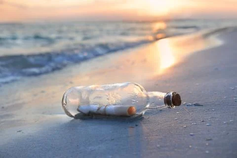 Message in a bottle at sunset Stock Photos
