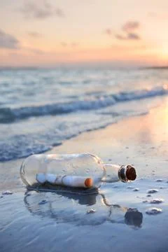 Message in a bottle at sunset Stock Photos