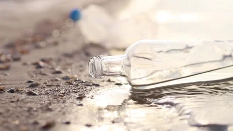 Message in a bottle uncovered on a serene beach at sunrise 스톡 동영상 295284064