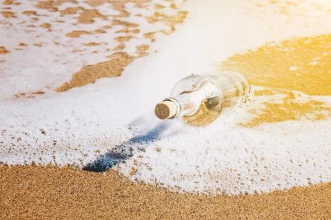 Message in a bottle washed up by the sea Stock Photos