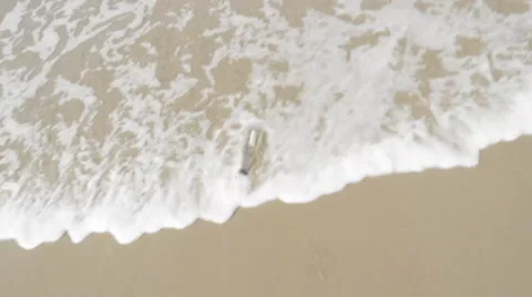 Message in a Bottle Washing Up on Shore Stock Footage 34473302