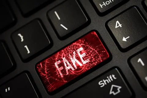 Message on broken red enter key of keyboard. Computer fake news attack warnin Stock Photos