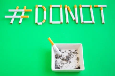 Message with cigars on green background Stock Photos