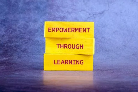 The message connect through learning. EMPOWERMENT THROUGH LEARNING on wooden Stock Photos