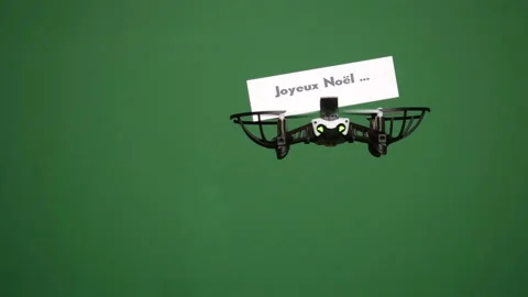 Message delivery by drone : season's greetings on a green screen Stock Footage 99349381