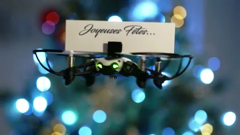 Message delivery by drone : season's greetings  with christmas tree bokeh Stock Footage 99548353