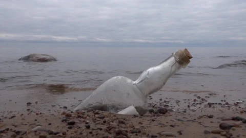Message in a glass Bottle washed ashore Stock Footage 239565671