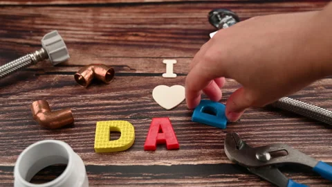 Message I LOVE DAD with different copper water pipe and fittings plumber tool Stock Footage 153985583