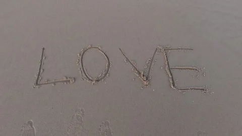 The message'' love '' on the sand with hand drawing on the beach 動画素材 245710994