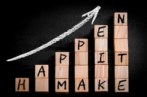 Message MAKE IT HAPPEN  on ascending arrow above bar graph of Wooden small cubes Stock Photos