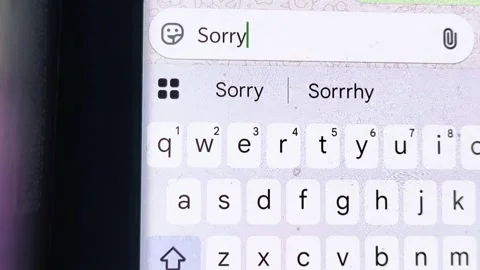 A message on a mobile phone spelling I am sorry. Typing sorry sms. Video stock 310634902