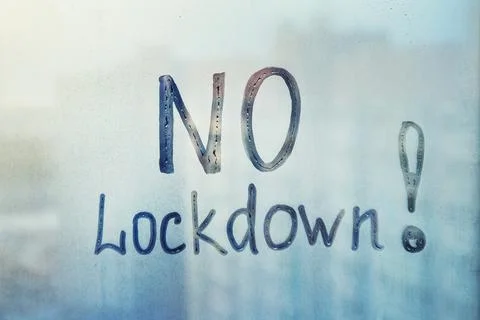Message, NO lockdown are painted handwriting on wet blue glass of window in l Stock Photos