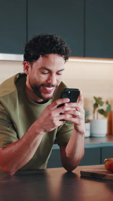 Message, online and happy man with phone in kitchen, internet search and Stock Footage 346938523