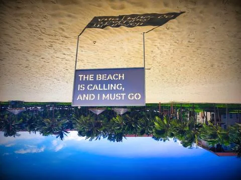 Message on a sign at the beach indicates a call to enjoy the seaside Stock Photos